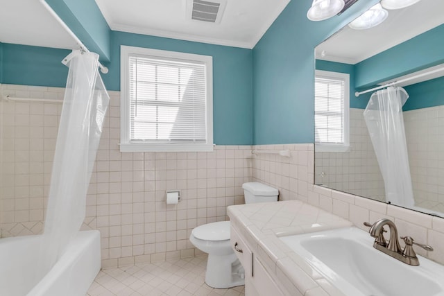 full bathroom featuring toilet, tile patterned flooring, tile walls, crown molding, and shower / tub combo with curtain