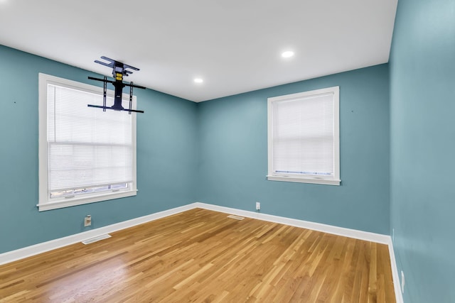 spare room with hardwood / wood-style floors