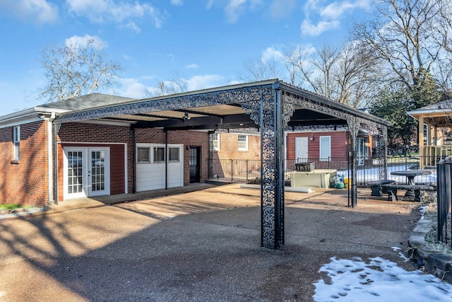 back of house featuring a water view and french doors