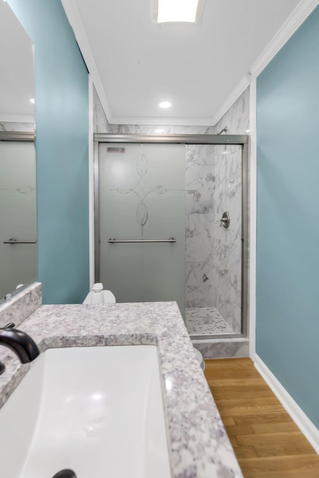 bathroom with toilet, vanity, hardwood / wood-style floors, crown molding, and an enclosed shower