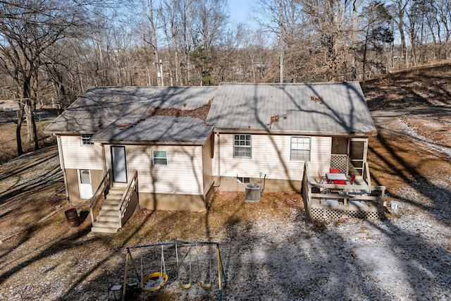 back of house featuring central AC unit