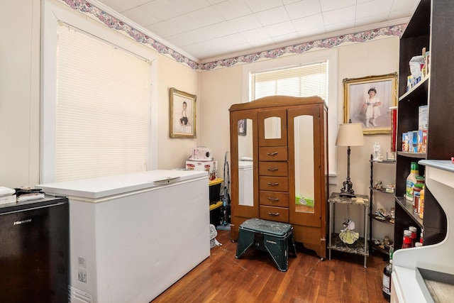 home office featuring dark hardwood / wood-style flooring and crown molding