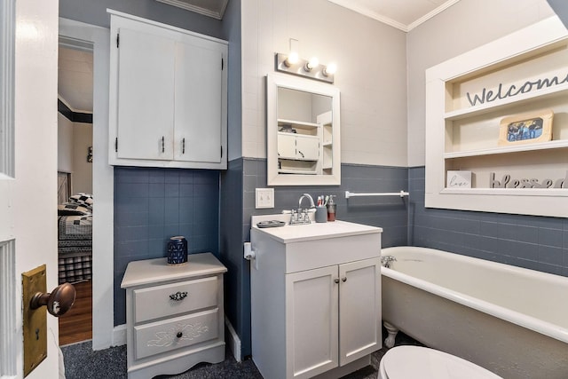 bathroom featuring toilet, a bath, ornamental molding, and vanity