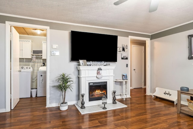 living room with ceiling fan, dark hardwood / wood-style floors, independent washer and dryer, crown molding, and a textured ceiling