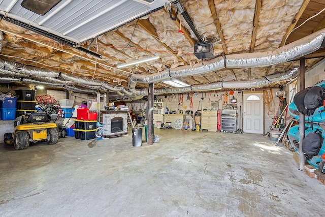 garage with a workshop area and a garage door opener