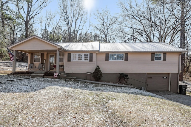 view of front of property featuring a garage and covered porch