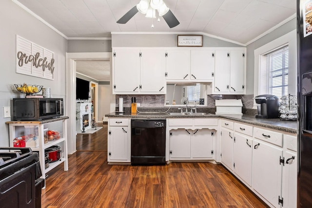 kitchen featuring backsplash, vaulted ceiling, black appliances, white cabinets, and sink