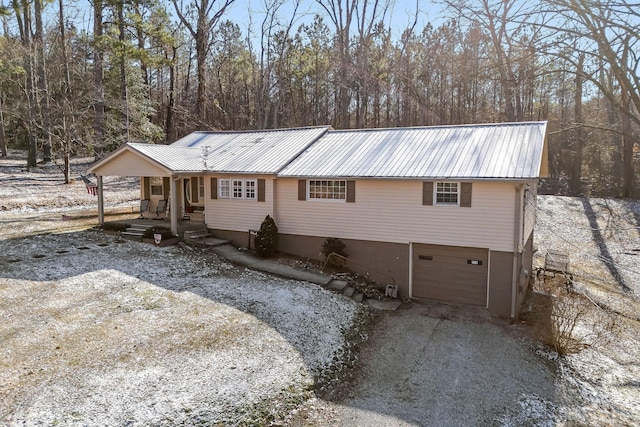 exterior space featuring covered porch and a garage