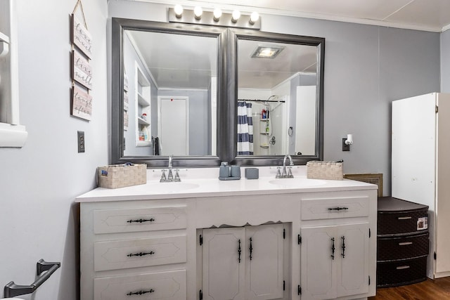 bathroom with crown molding, a shower with curtain, wood-type flooring, and vanity