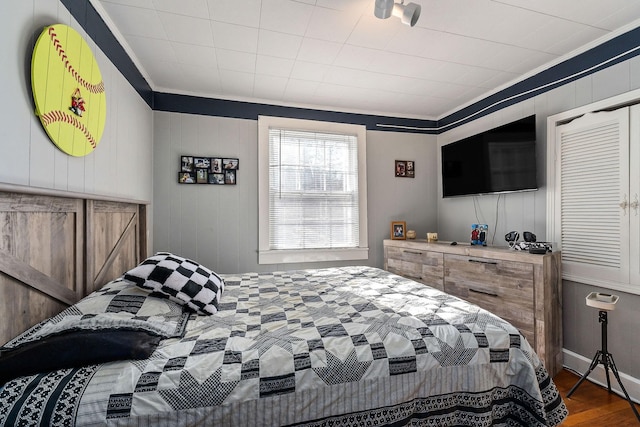 bedroom with crown molding and hardwood / wood-style floors