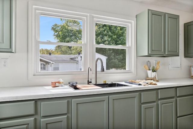 interior space with sink and green cabinetry