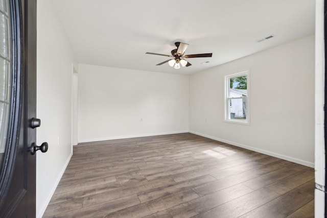 empty room with ceiling fan and hardwood / wood-style flooring