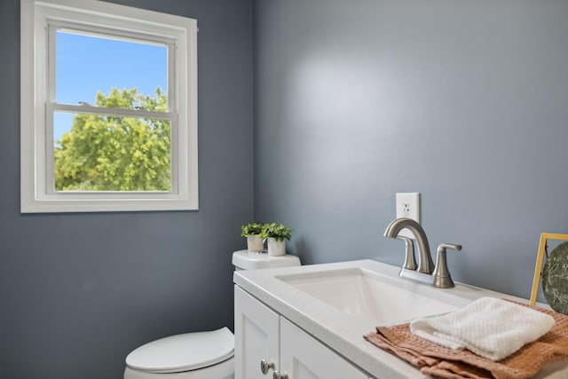 bathroom featuring toilet and vanity