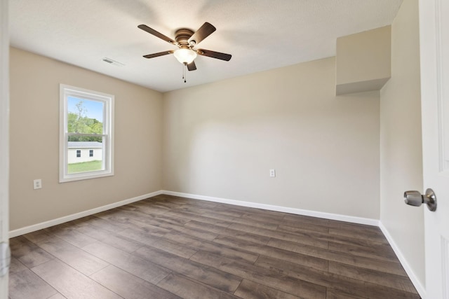 empty room featuring ceiling fan and dark hardwood / wood-style floors