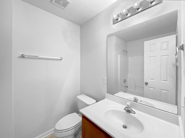 full bathroom with vanity, toilet, bathtub / shower combination, and a textured ceiling