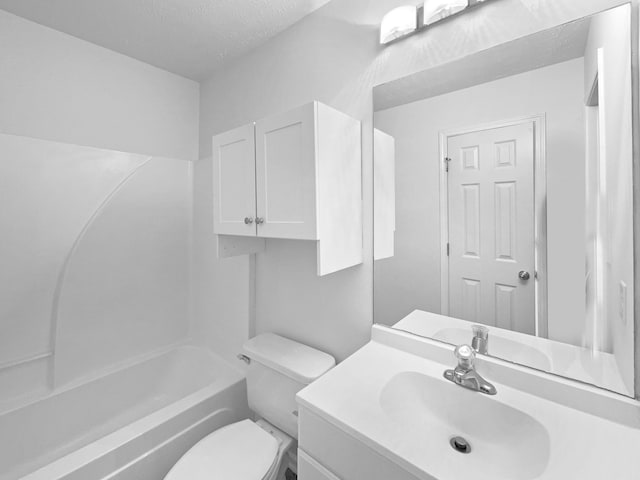 full bathroom with toilet, bathing tub / shower combination, a textured ceiling, and vanity