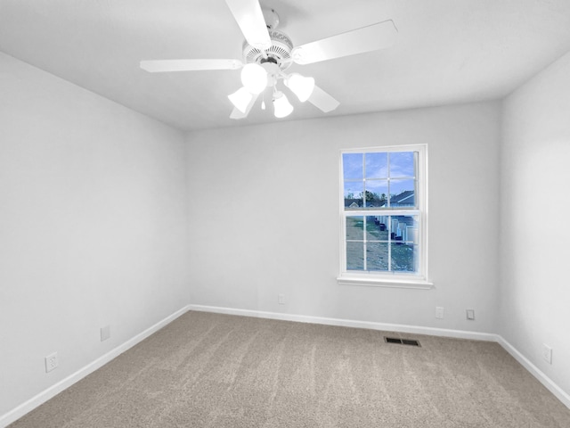 empty room featuring carpet floors and ceiling fan