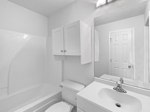 full bathroom featuring vanity, toilet, a textured ceiling, and bathing tub / shower combination