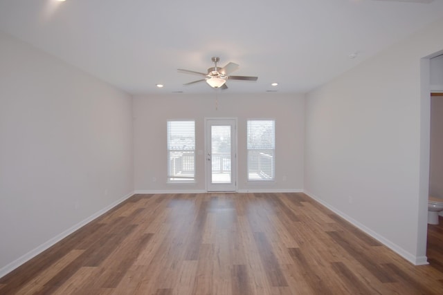 empty room with hardwood / wood-style flooring and ceiling fan