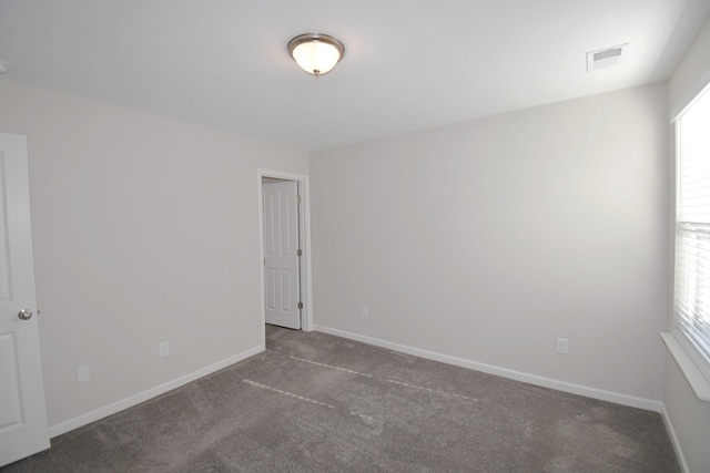 empty room with dark carpet