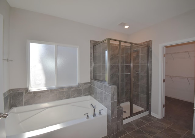 bathroom featuring tile patterned flooring and plus walk in shower