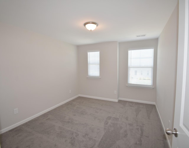 carpeted empty room with plenty of natural light