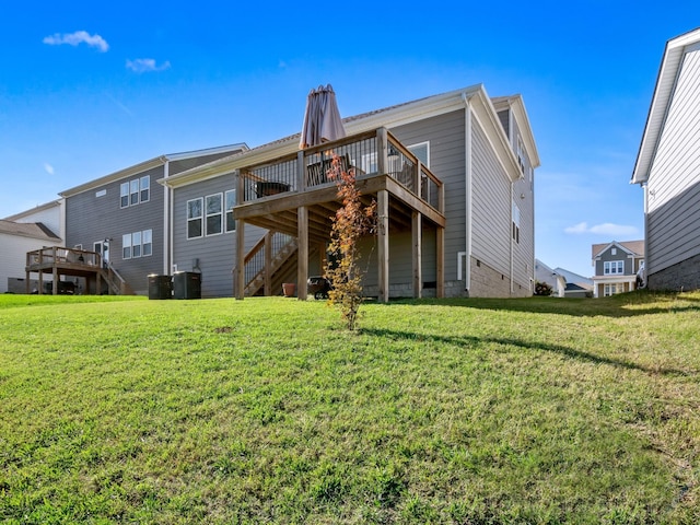 rear view of house featuring a wooden deck, cooling unit, and a yard