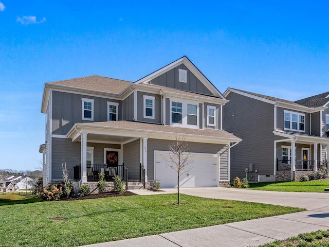 craftsman house with a garage, a front yard, and covered porch