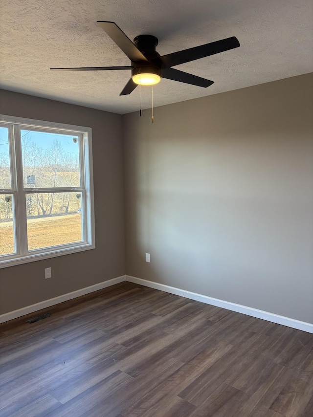 unfurnished room with a textured ceiling, ceiling fan, and dark hardwood / wood-style flooring