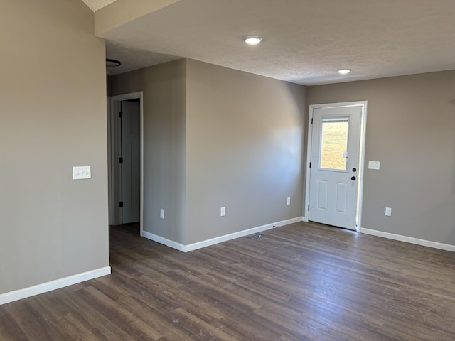 spare room with dark wood-type flooring