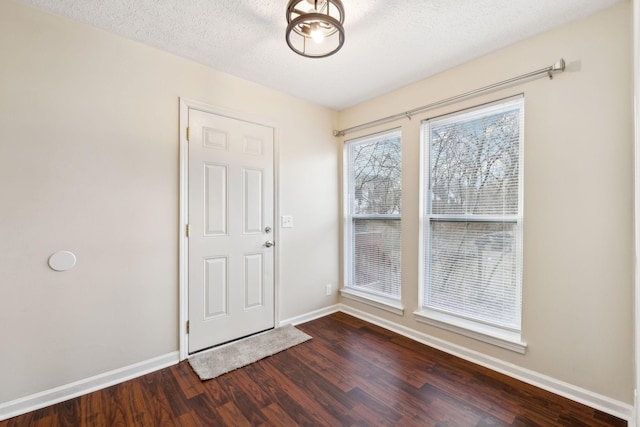 interior space featuring wood-type flooring and a textured ceiling