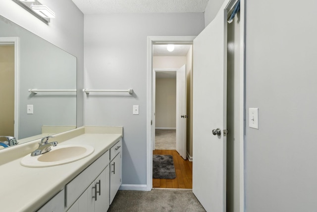 bathroom with a textured ceiling and vanity