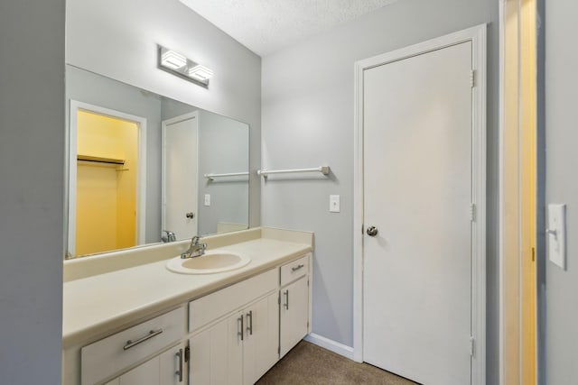 bathroom featuring a textured ceiling and vanity