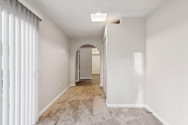 hall featuring light colored carpet