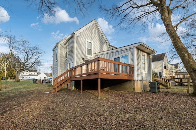 rear view of house with a deck and central AC unit