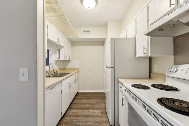 kitchen featuring white cabinetry, sink, tasteful backsplash, and white appliances