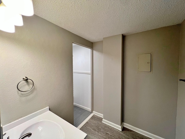 bathroom featuring vanity, a textured ceiling, and hardwood / wood-style floors