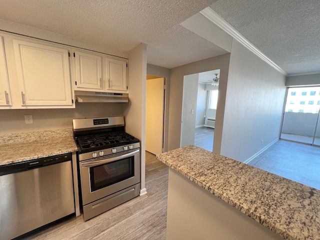 kitchen with white cabinetry, light hardwood / wood-style flooring, a textured ceiling, ornamental molding, and stainless steel appliances