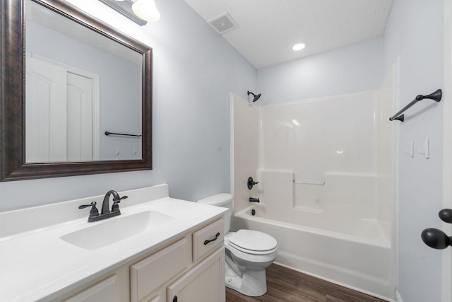 full bathroom with wood-type flooring, toilet, vanity, and  shower combination