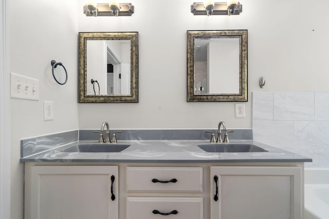 bathroom with a bathing tub, tasteful backsplash, and vanity