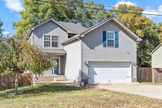 view of property featuring a front yard and a garage