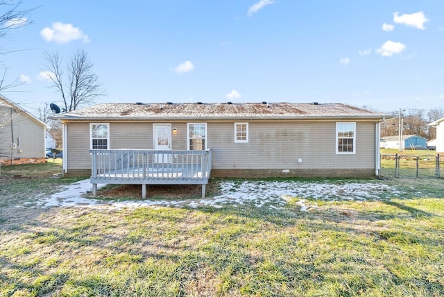 back of house with a lawn and a deck