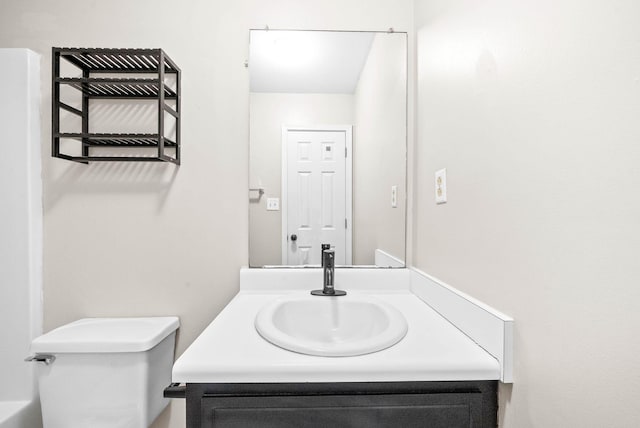 bathroom featuring toilet and vanity