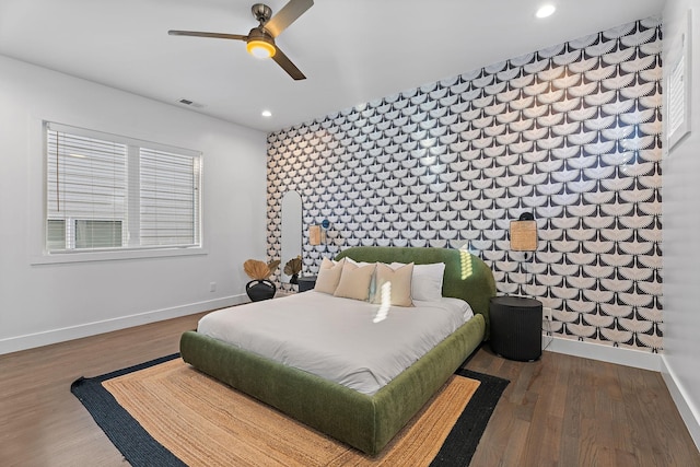 bedroom with ceiling fan and hardwood / wood-style floors