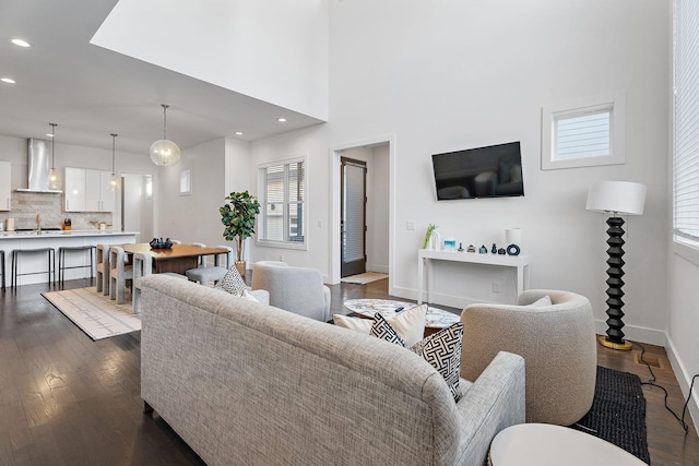 living room featuring sink and dark hardwood / wood-style flooring