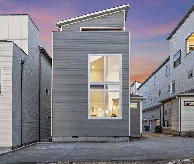 view of back house at dusk