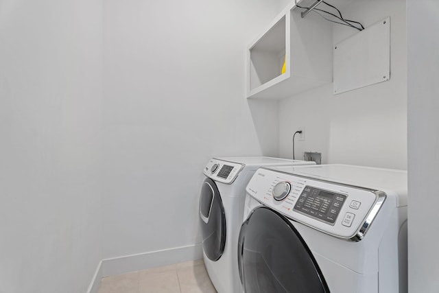 laundry area featuring separate washer and dryer and light tile patterned floors