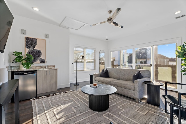 living room with ceiling fan, dark wood-type flooring, and sink