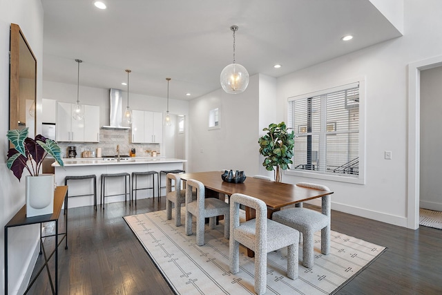 dining room featuring dark wood-type flooring and sink