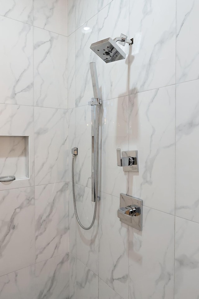 bathroom with a tile shower